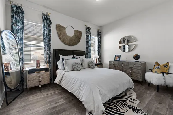 a bedroom with bed and a mirror