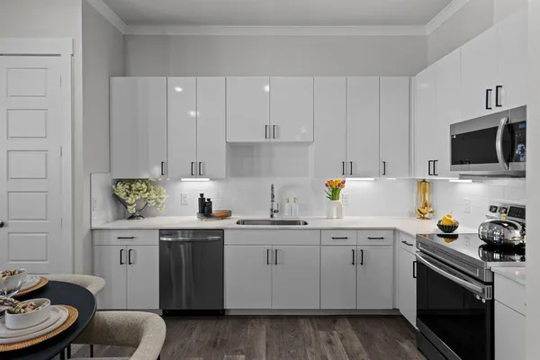 a kitchen with a sink window and cabinets