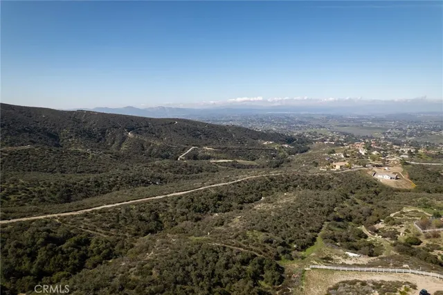 a view of a big yard with large trees