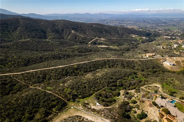 a view of a backyard with wooden fence
