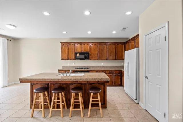 a kitchen with a stove a refrigerator and a microwave