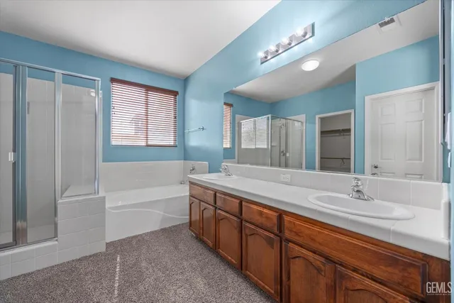 a bathroom with a tub shower and a sink