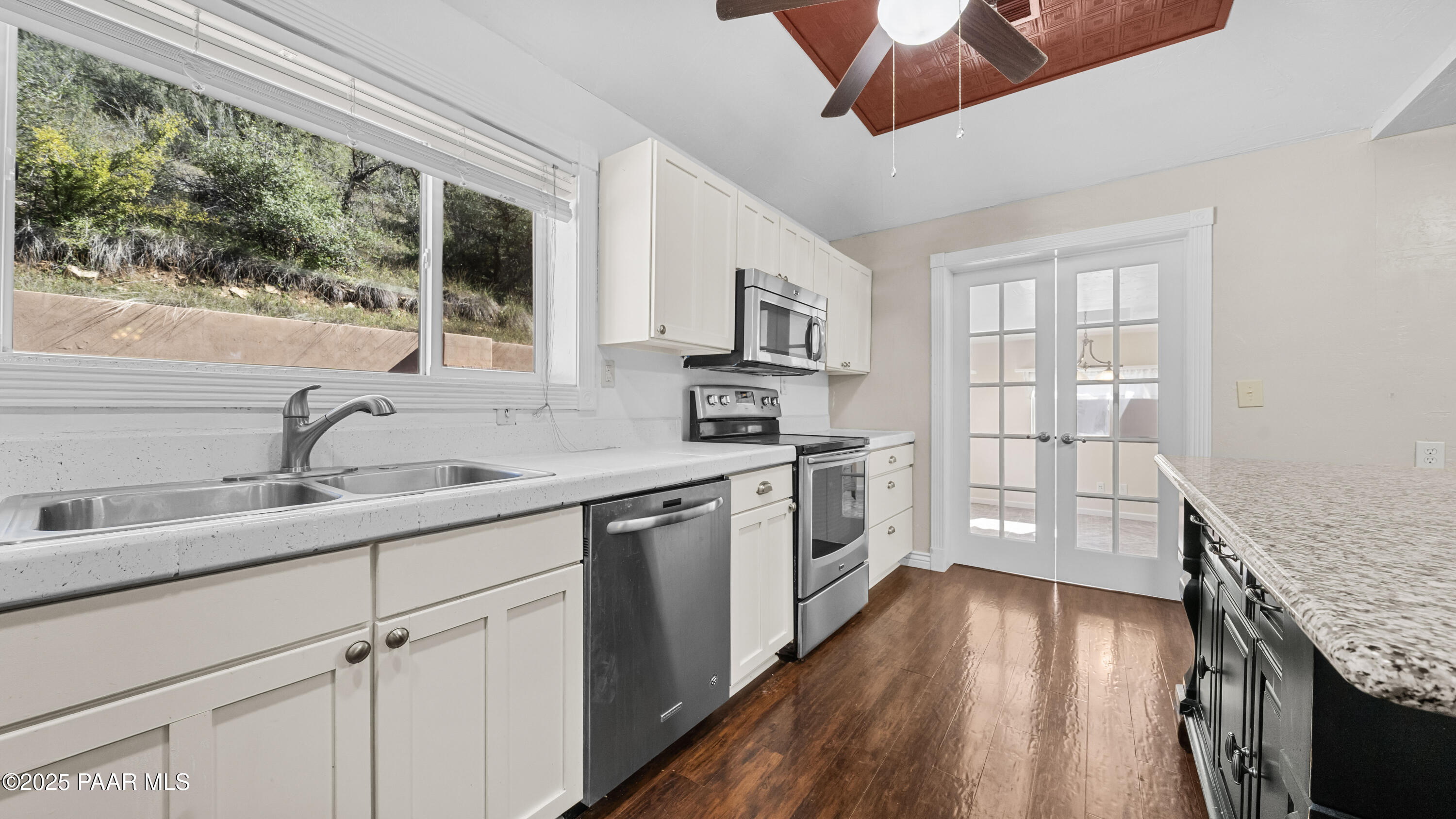 249 South Lynx Creek Road Prescott, AZ 86303 - Photo 12 of 124 a kitchen with a sink cabinets stainless steel appliances and a large window