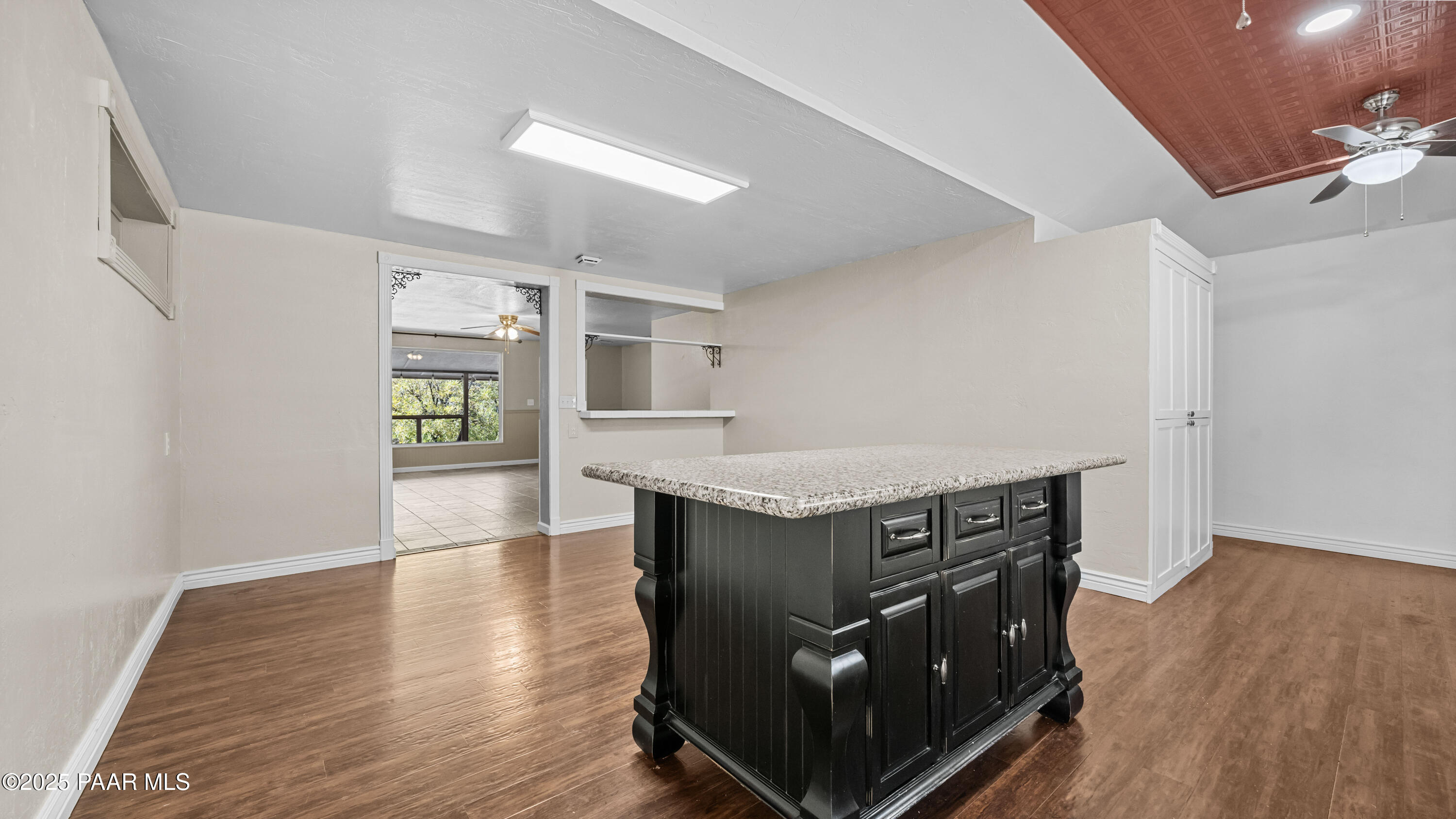 249 South Lynx Creek Road Prescott, AZ 86303 - Photo 18 of 124 a kitchen with granite countertop a stove and a wooden floors