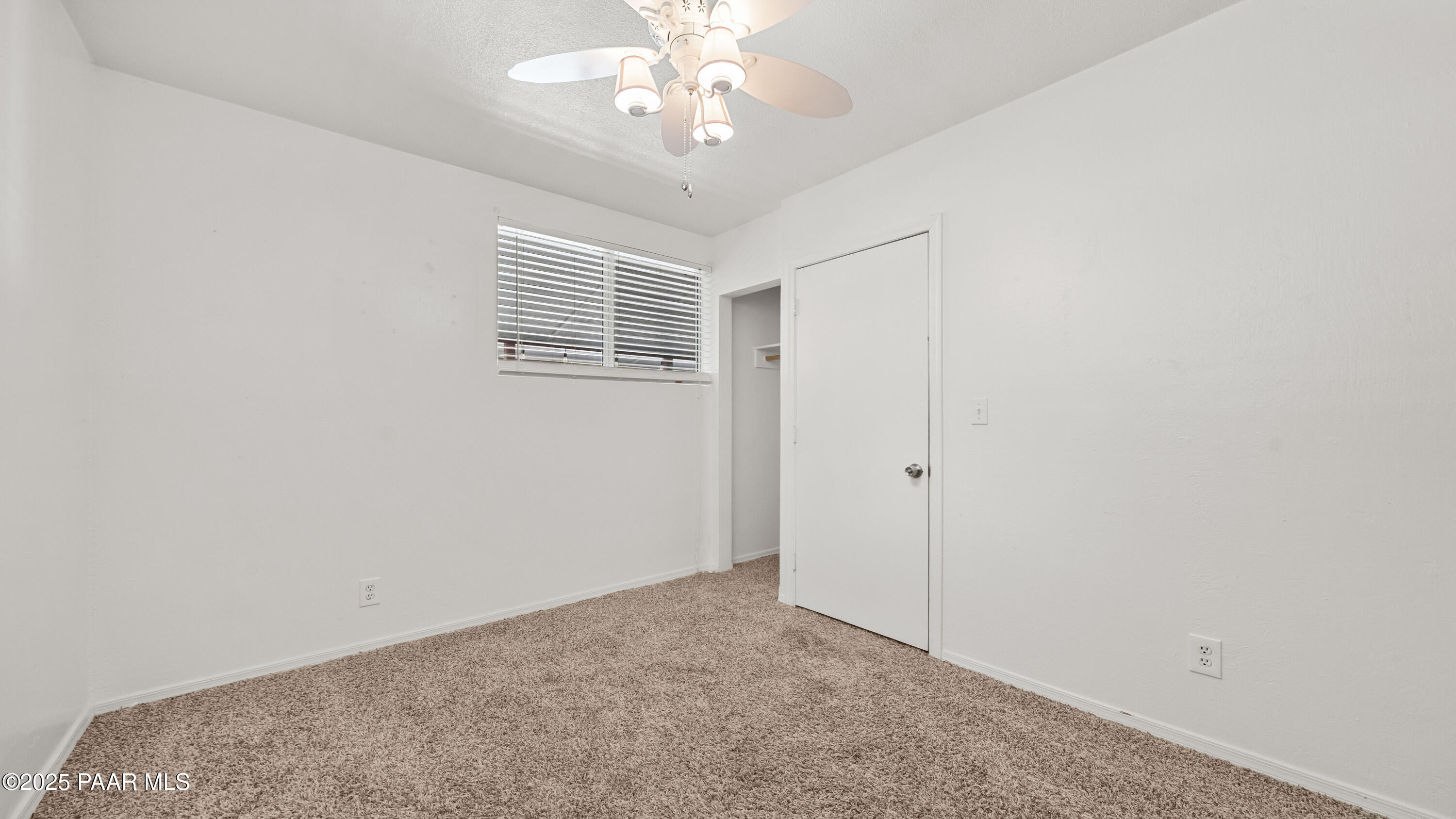 249 South Lynx Creek Road Prescott, AZ 86303 - Photo 36 of 124 an empty room with a chandelier fan and windows