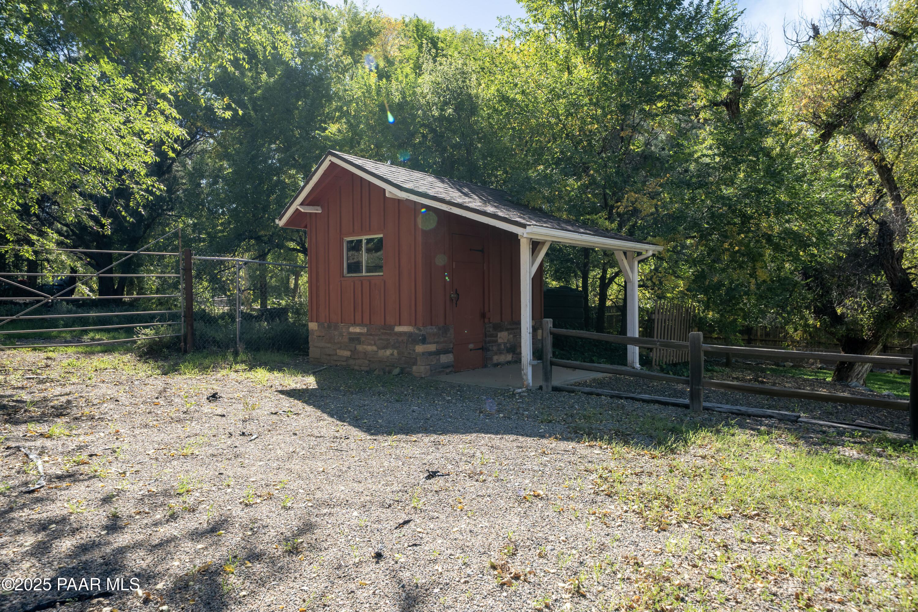 249 South Lynx Creek Road Prescott, AZ 86303 - Photo 60 of 124 a backyard of a house with a large tree and wooden fence