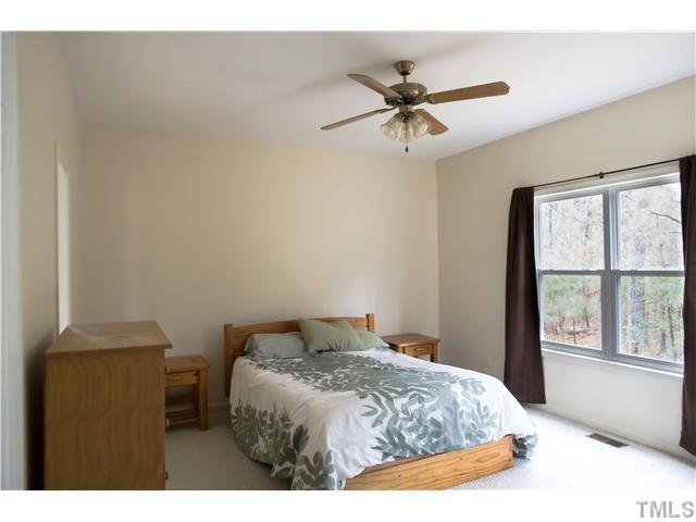 135 Ridge Road Butner, NC 27509 - Photo 7 of 25 Spacious master bedroom, with separate private full length glass/wooden door leading to the deck.
