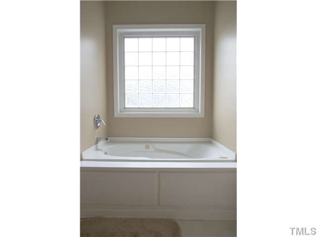 135 Ridge Road Butner, NC 27509 - Photo 10 of 25 large tub, with glass block decorative window above tub for lots of daylight while also offering privacy.