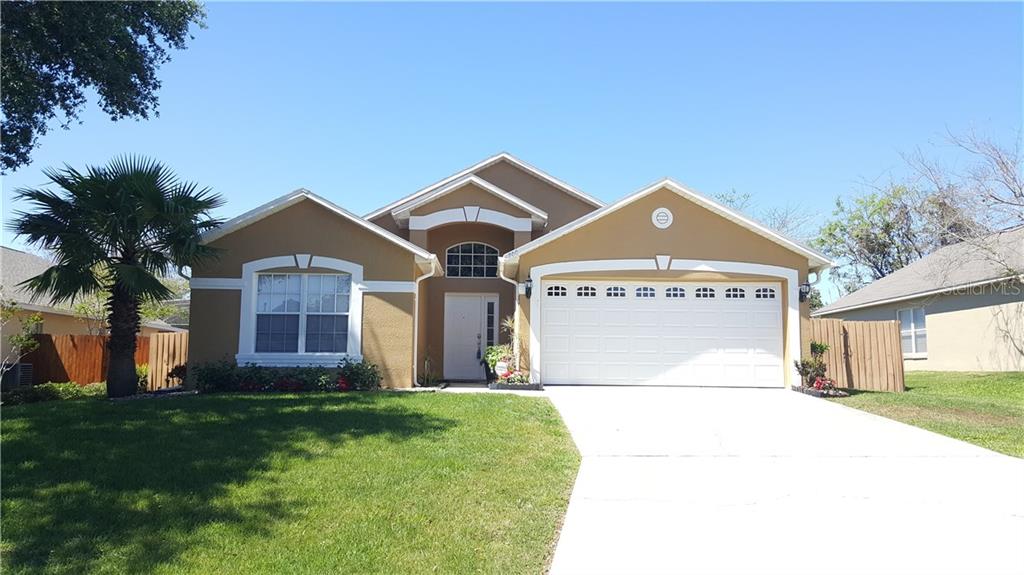 700 Durango Loop Street Davenport, FL 33897 - Photo 1 of 1 a front view of a house with garden