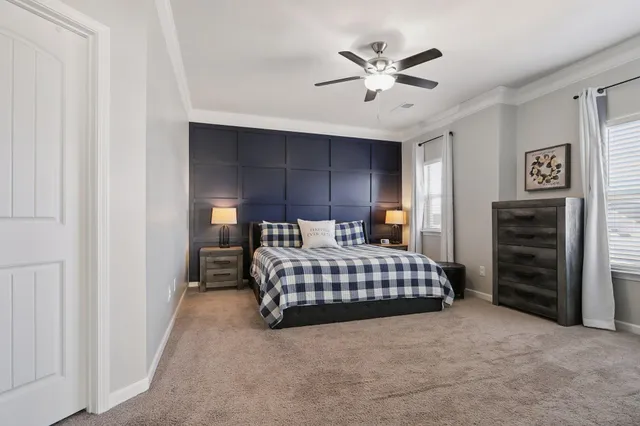 a bedroom with a bed and flat screen tv