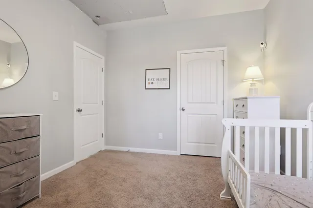 a bedroom with a bed and cabinets
