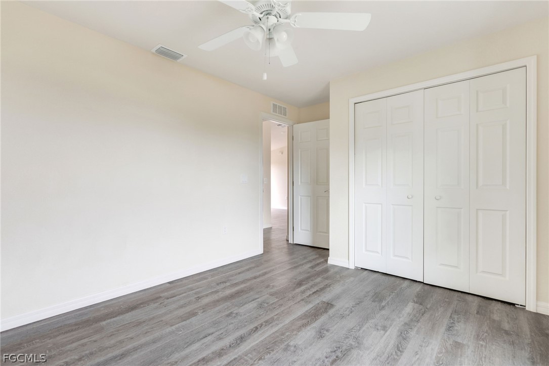 1405 Inwood Road LaBelle, FL 33935 - Photo 28 of 35 a view of an empty room with wooden floor