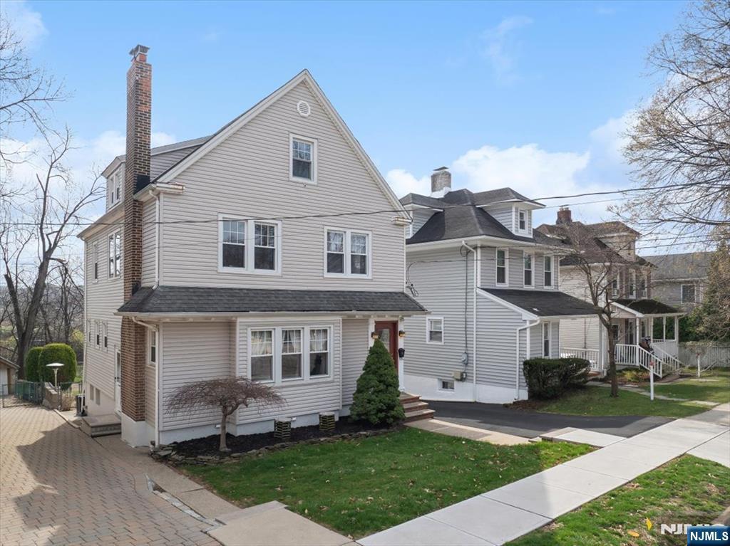 119 Overpeck Avenue Ridgefield Park, NJ 07660 - Photo 34 of 44 a front view of a house with a yard
