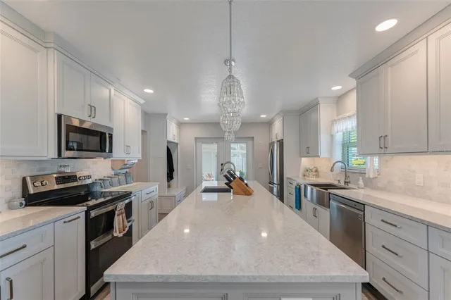 a kitchen with refrigerator and cabinets