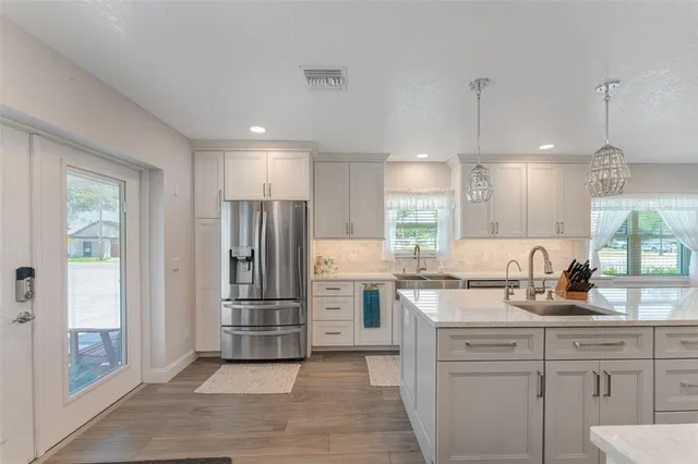 a spacious bedroom with a bed and a chandelier