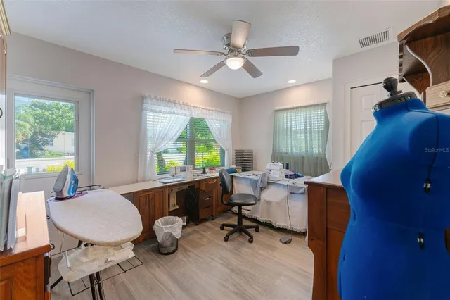 a bathroom with a sink toilet vanity and window