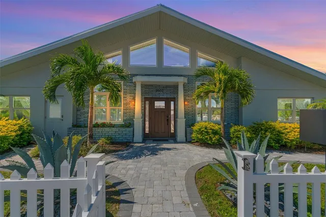 a house with a yard and potted plants