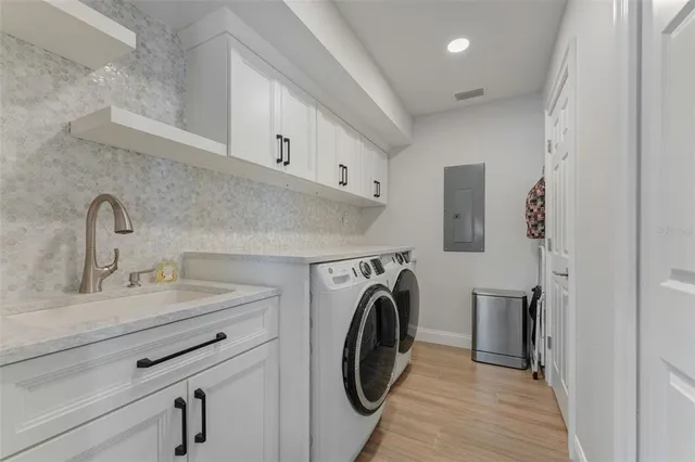 a kitchen with a white cabinets and couches