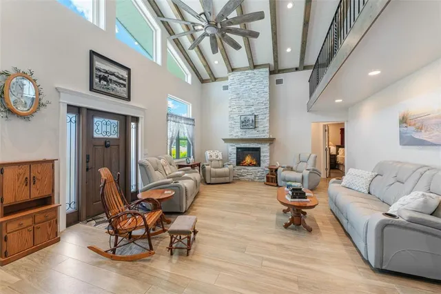 a living room with furniture a fireplace and a flat screen tv