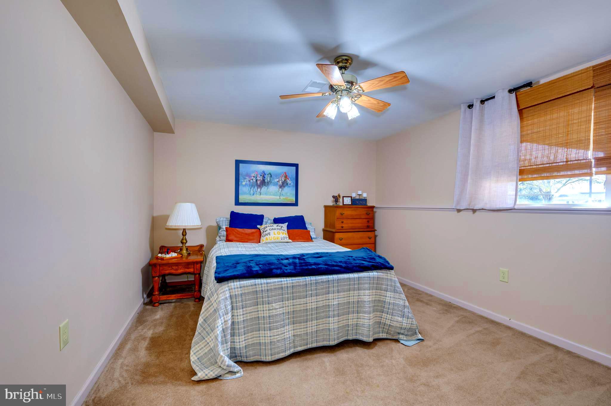 78 Baltusrol Drive Charles Town, WV 25414 - Photo 14 of 26 a bedroom with a bed and a chandelier