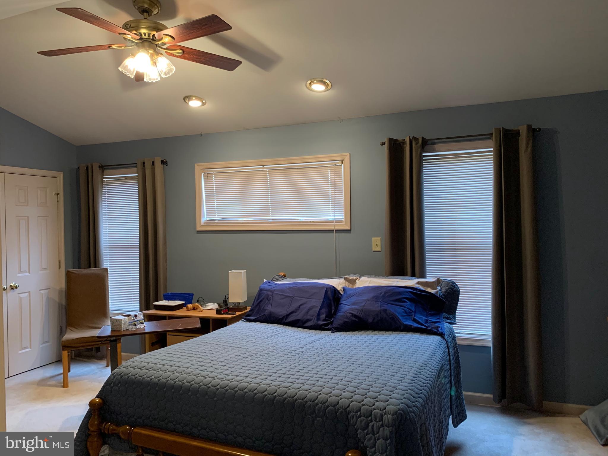 78 Baltusrol Drive Charles Town, WV 25414 - Photo 21 of 26 a bedroom with a bed and a chandelier