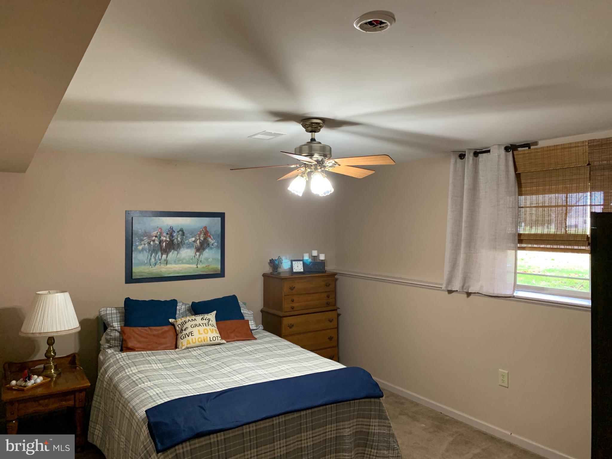 78 Baltusrol Drive Charles Town, WV 25414 - Photo 24 of 26 a bedroom with a bed and a chandelier