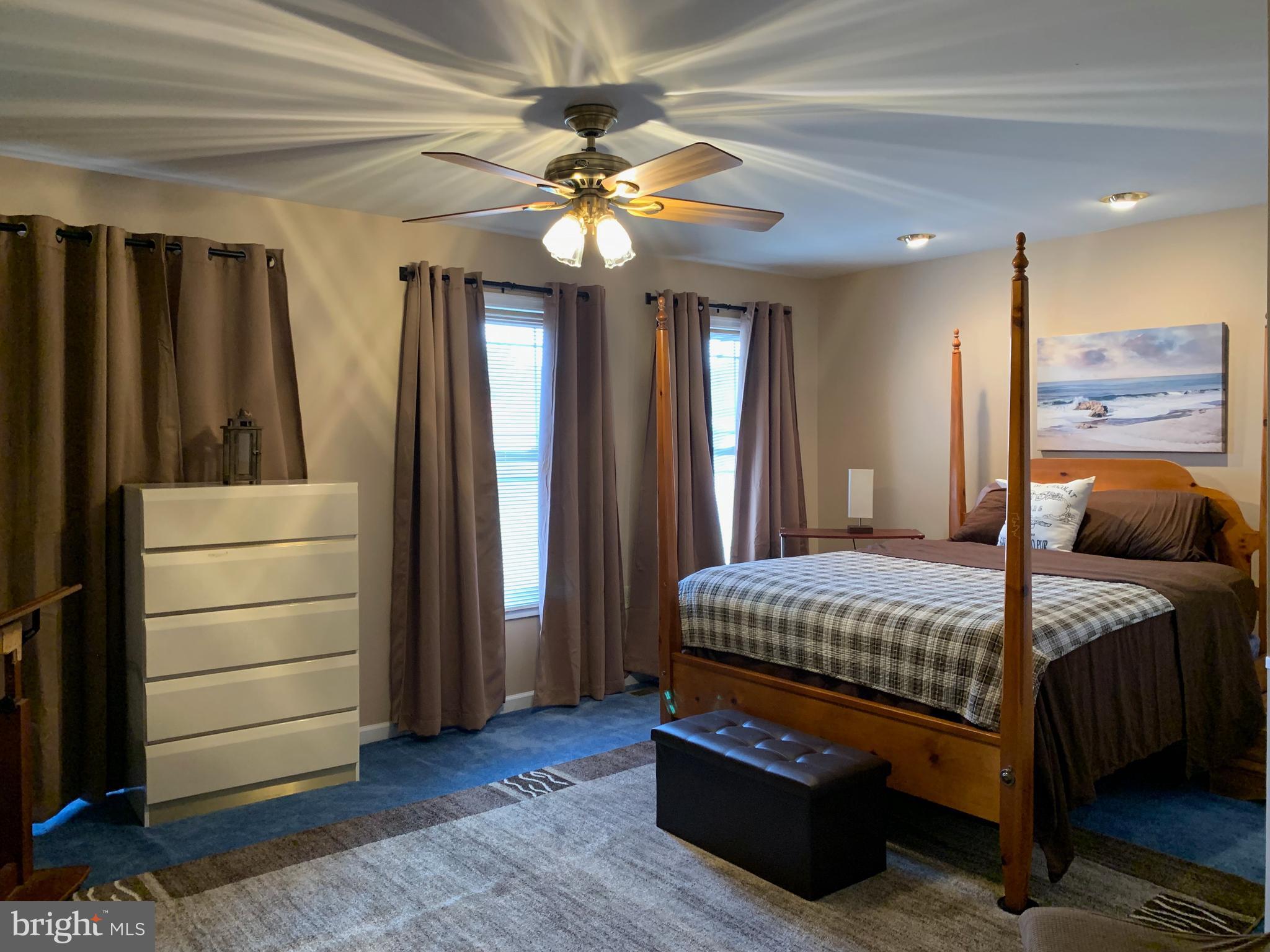 78 Baltusrol Drive Charles Town, WV 25414 - Photo 3 of 26 a bedroom with a bed and a chandelier