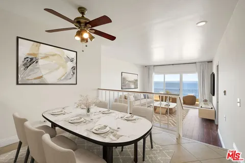 a view of a dining room with furniture and a large window