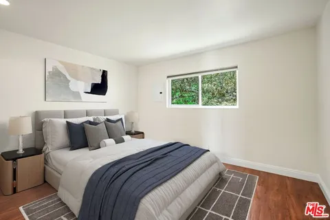 a bedroom with bed and a window