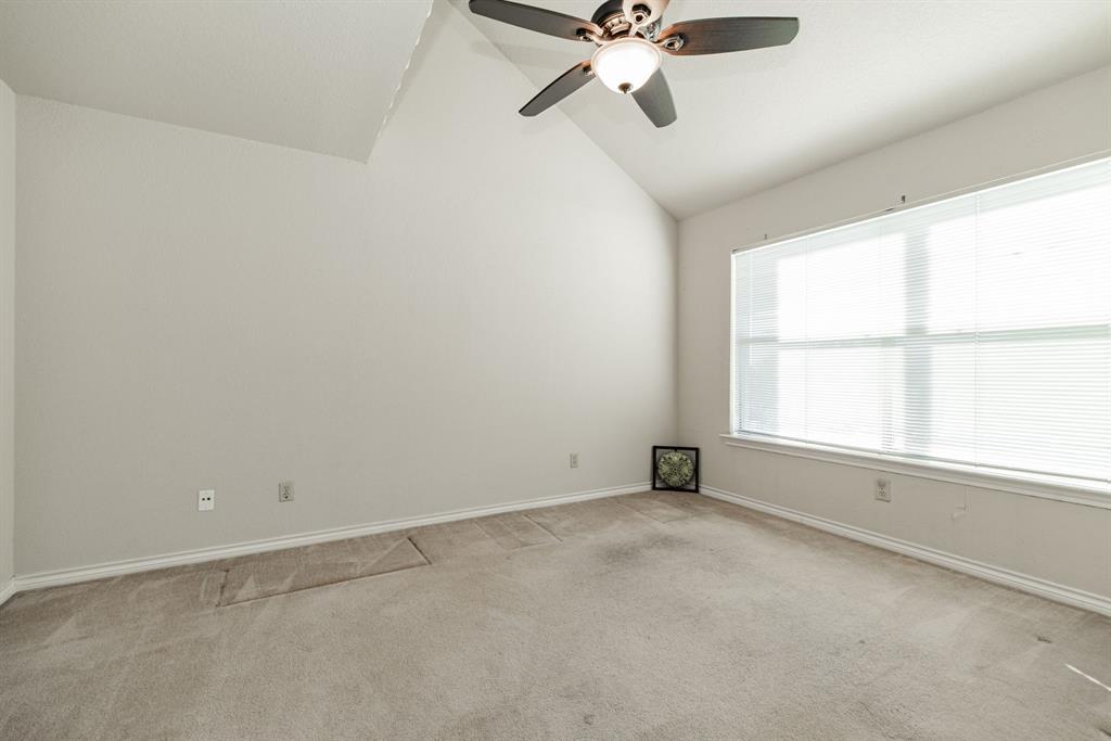 1106 Signal Ridge Place Rockwall, TX 75032 - Photo 15 of 32 Empty room featuring lofted ceiling, light colored carpet, and ceiling fan