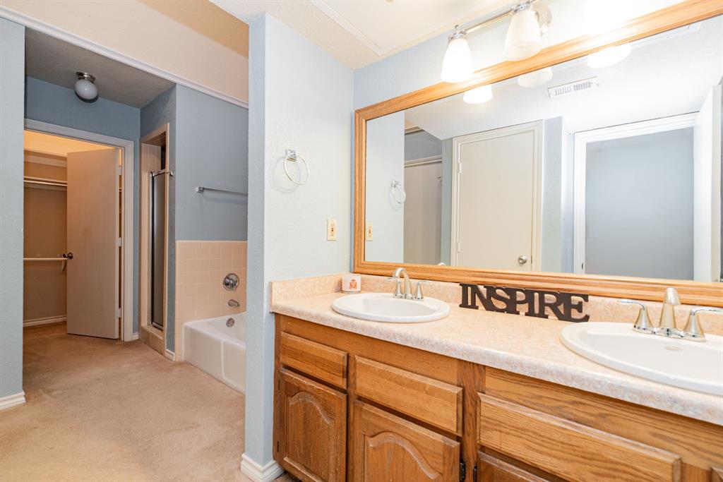 1106 Signal Ridge Place Rockwall, TX 75032 - Photo 22 of 32 a bathroom with a sink and a mirror