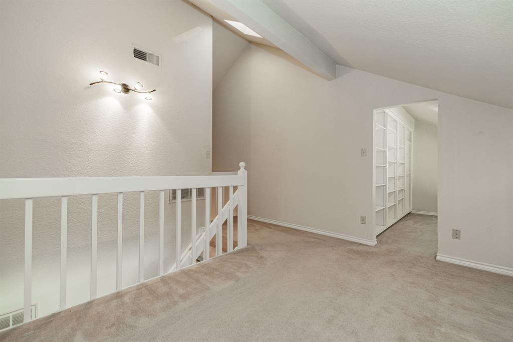1106 Signal Ridge Place Rockwall, TX 75032 - Photo 25 of 32 Additional living space featuring carpet and lofted ceiling