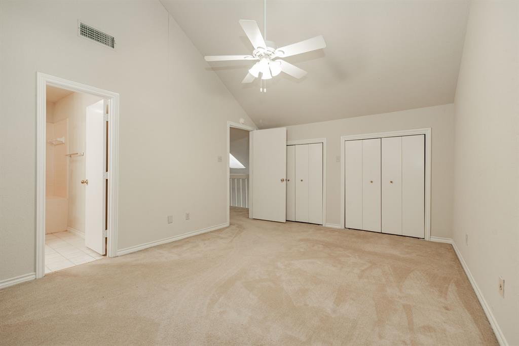 1106 Signal Ridge Place Rockwall, TX 75032 - Photo 30 of 32 Unfurnished bedroom with multiple closets, high vaulted ceiling, light carpet, ceiling fan, and connected bathroom