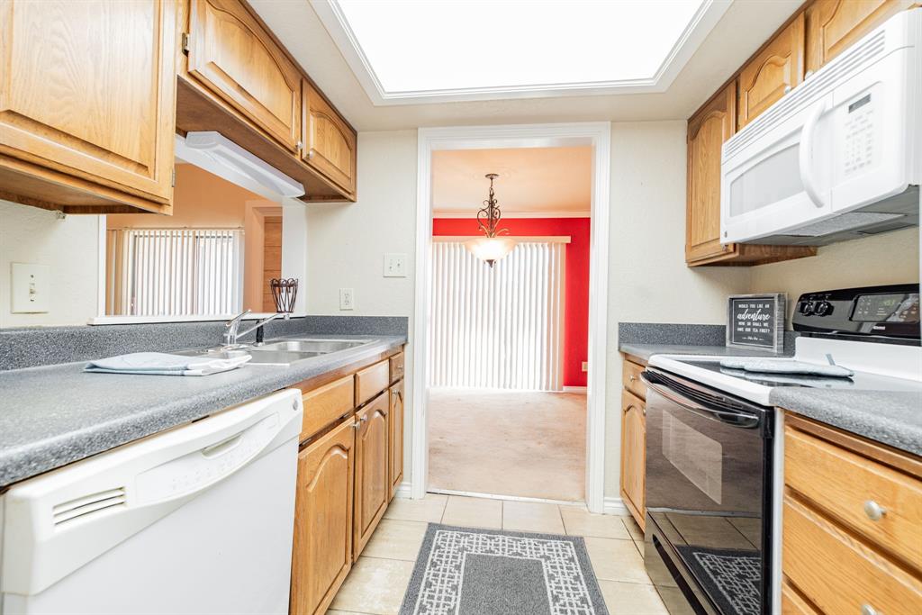 1106 Signal Ridge Place Rockwall, TX 75032 - Photo 8 of 32 a kitchen with stainless steel appliances granite countertop a sink and a stove