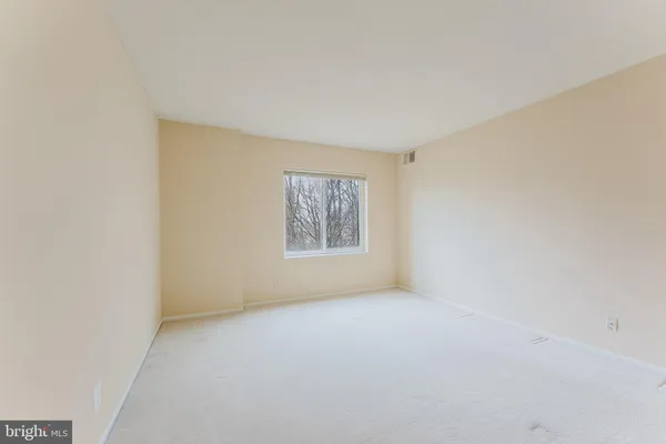a view of an empty room with windows