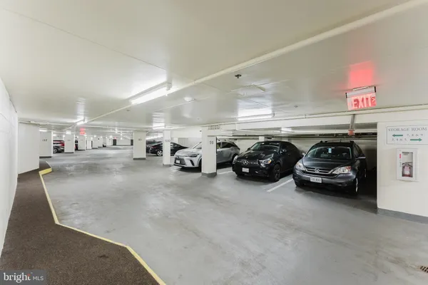 a view of a street with cars parked in front of it