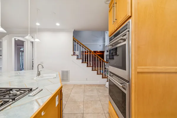 a view of a hallway with white walls and entryway