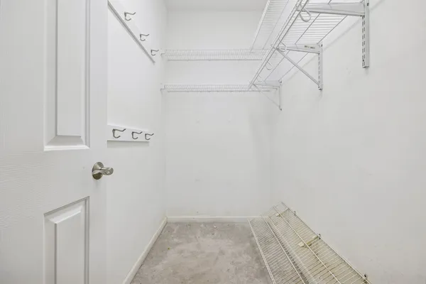 an empty room with a window and a ceiling fan