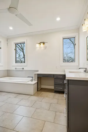 a view of a room with gym equipment and a chandelier fan