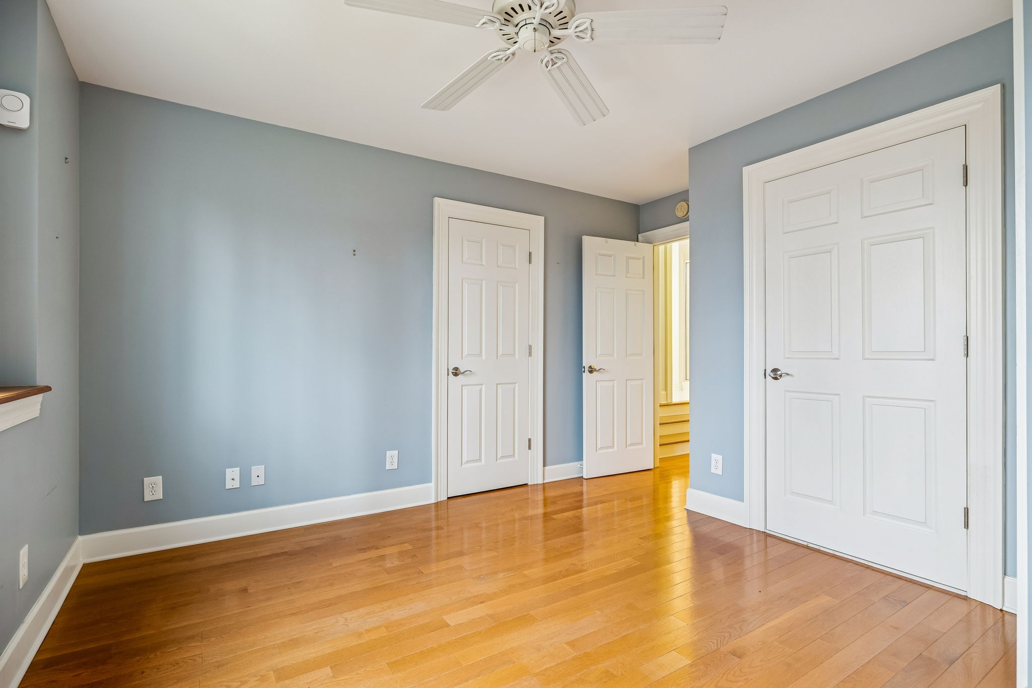 1010 Street Road Kingston Springs, TN 37082 - Photo 51 of 94 a view of an empty room with chandelier fan and wooden floor