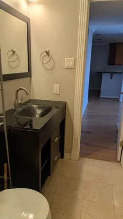 a bathroom with a sink a toilet and mirror