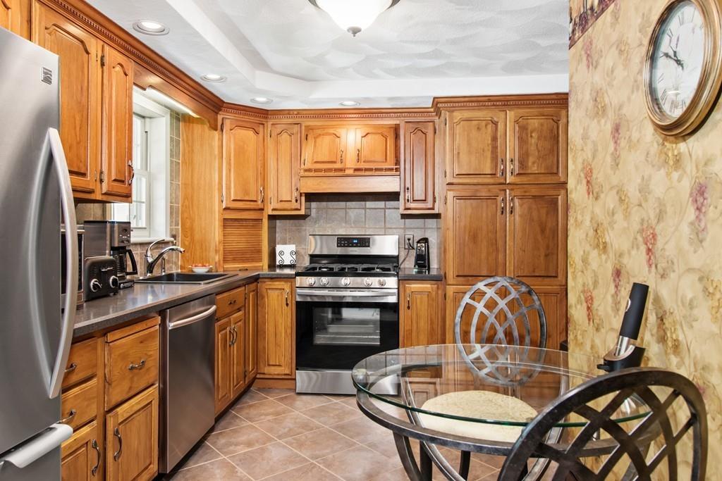 17 Janet Road Chelmsford, MA 01824 - Photo 8 of 28 a kitchen with stainless steel appliances granite countertop a stove a sink and a refrigerator