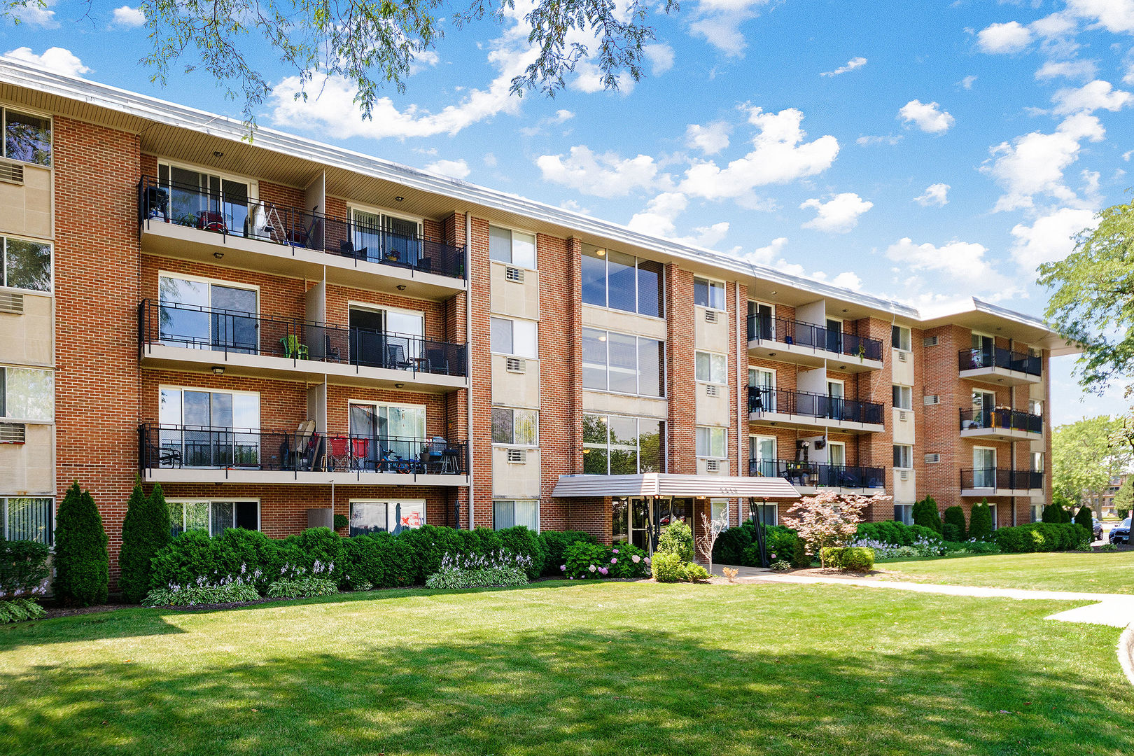 2210 South Goebbert Road, Unit 134 Arlington Heights, IL 60005 - Photo 1 of 10 a front view of building with yard