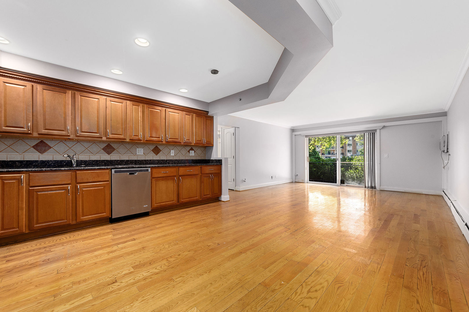 2210 South Goebbert Road, Unit 134 Arlington Heights, IL 60005 - Photo 2 of 10 a kitchen with stainless steel appliances granite countertop a sink cabinets and wooden floor