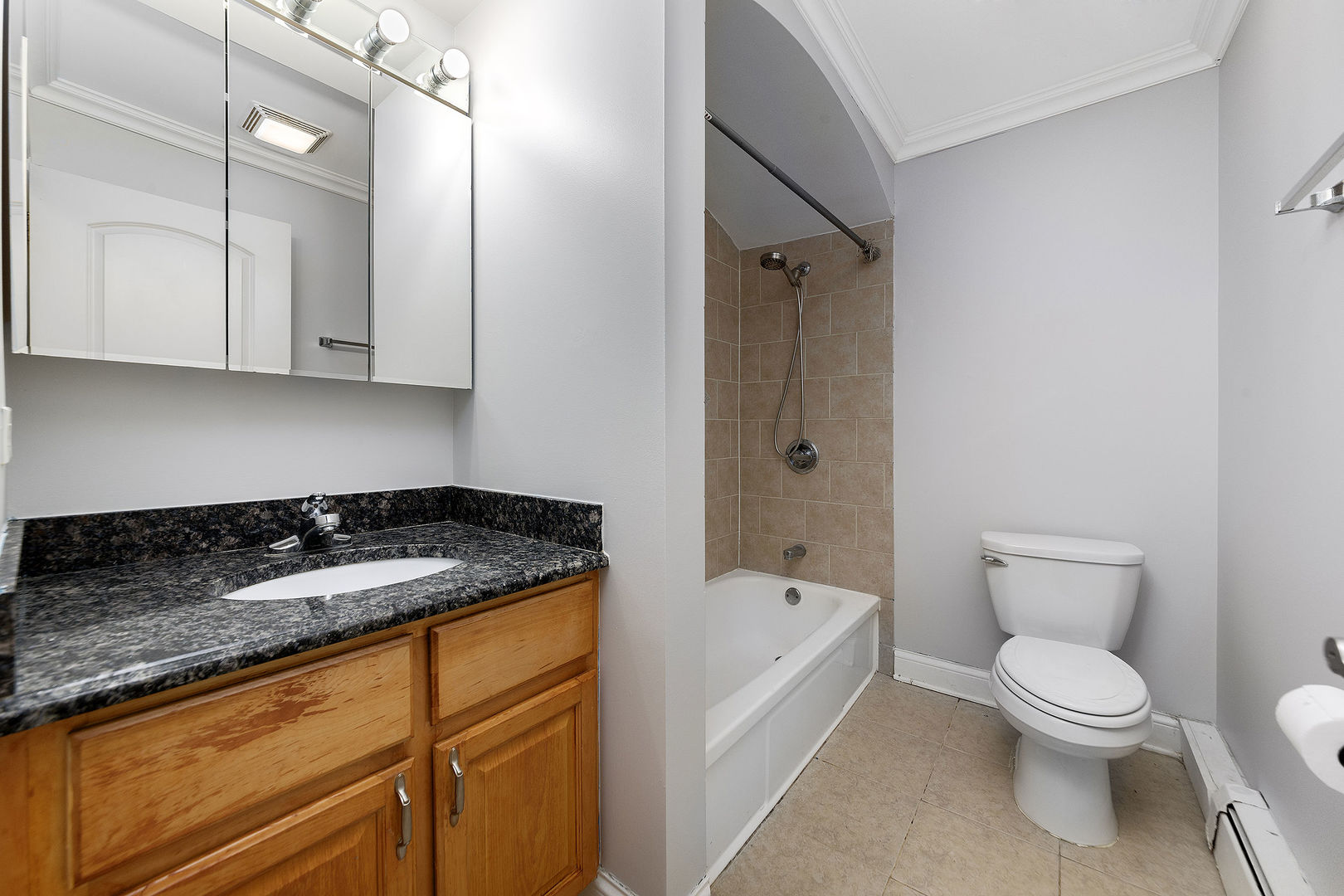 2210 South Goebbert Road, Unit 134 Arlington Heights, IL 60005 - Photo 5 of 10 a bathroom with a granite countertop sink toilet and shower