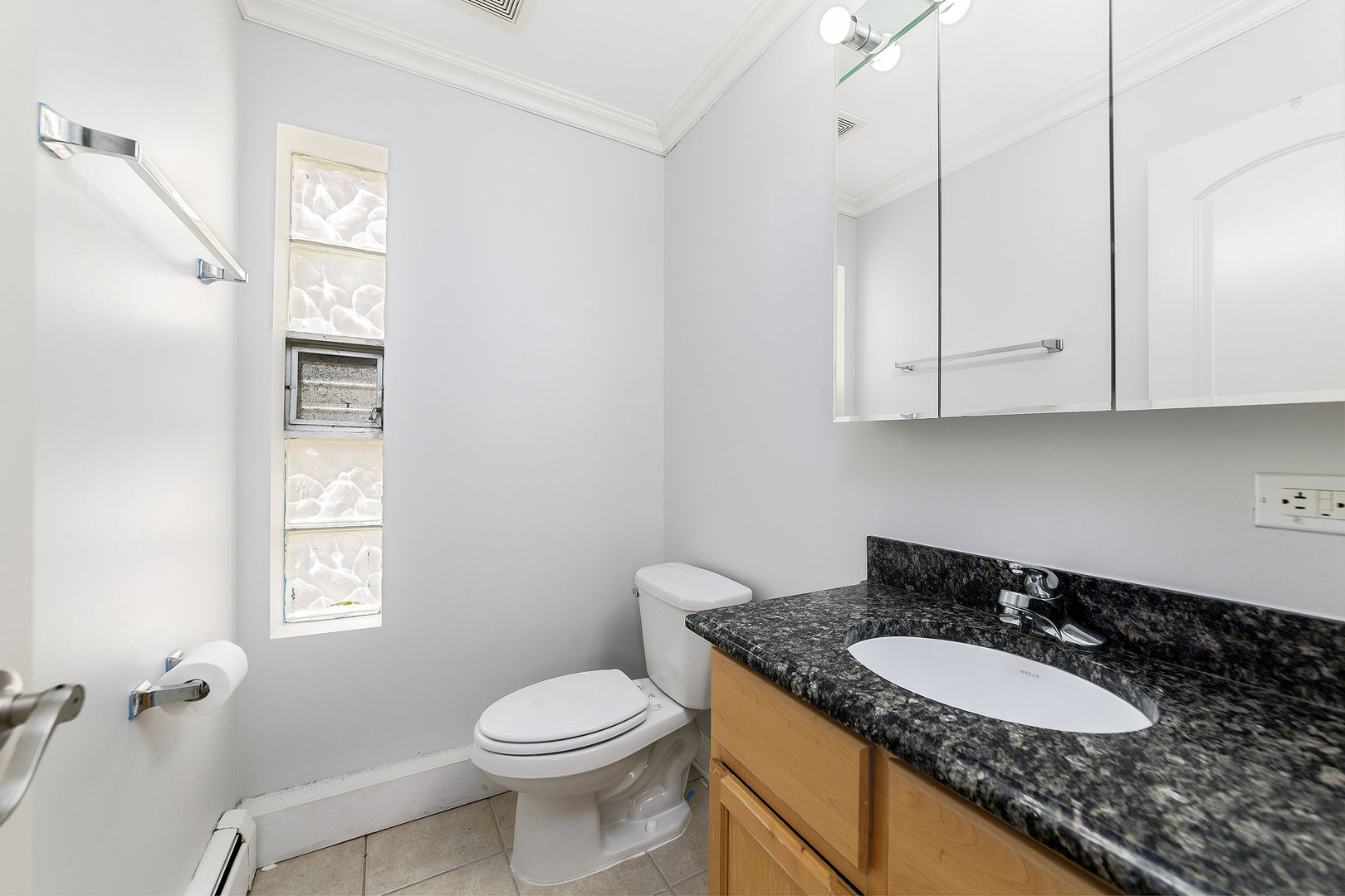 2210 South Goebbert Road, Unit 134 Arlington Heights, IL 60005 - Photo 7 of 10 a bathroom with a granite countertop sink toilet and mirror