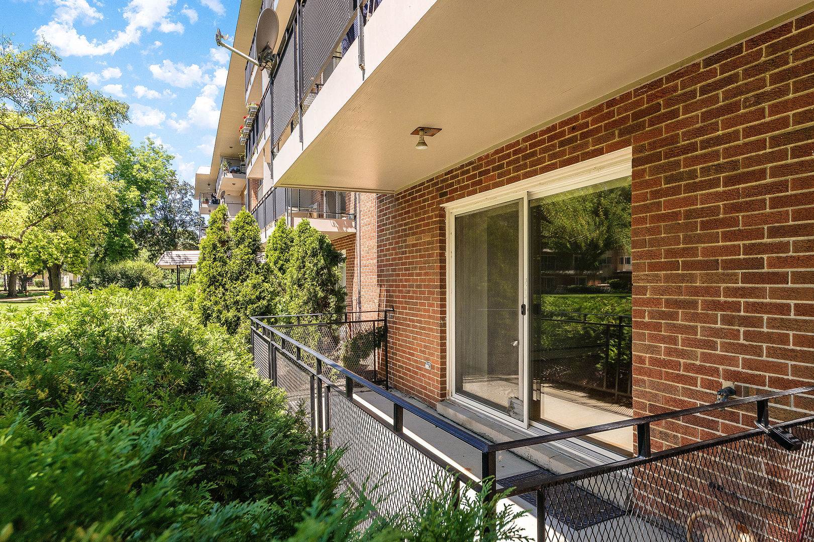 2210 South Goebbert Road, Unit 134 Arlington Heights, IL 60005 - Photo 9 of 10 a view of a balcony with chairs and floor to ceiling window