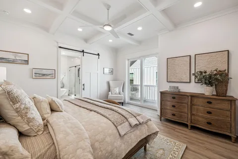a spacious bedroom with a bed and a dresser