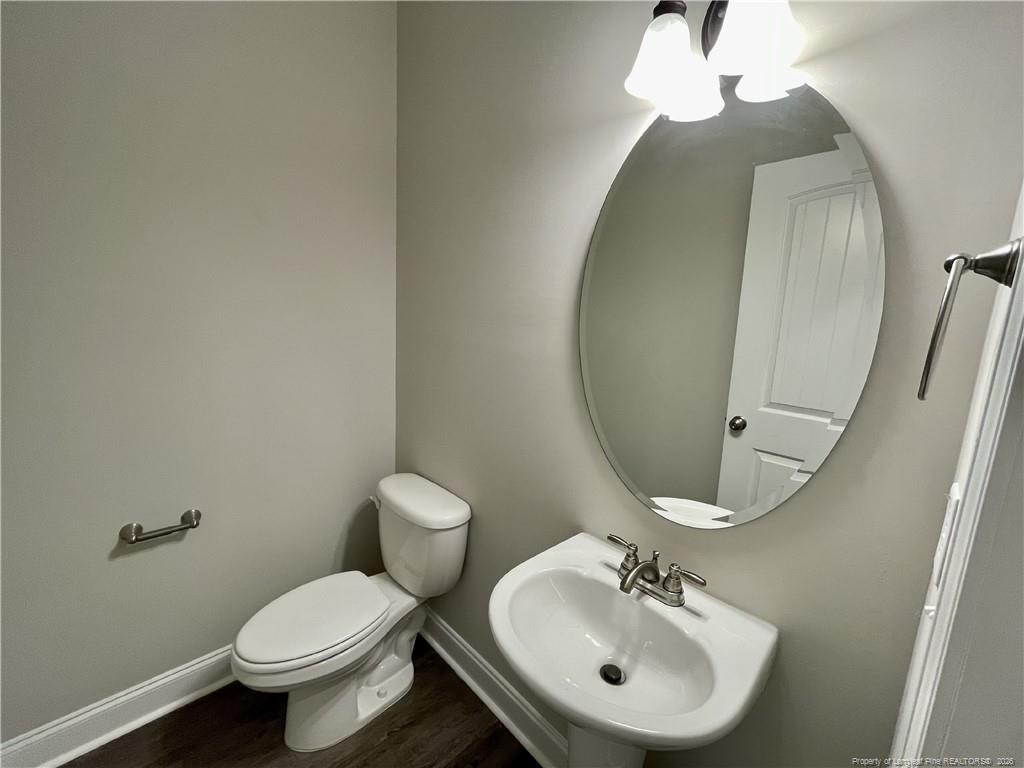 5177 Maxwell Road Stedman, NC 28391 - Photo 22 of 24 a bathroom with a toilet sink and mirror