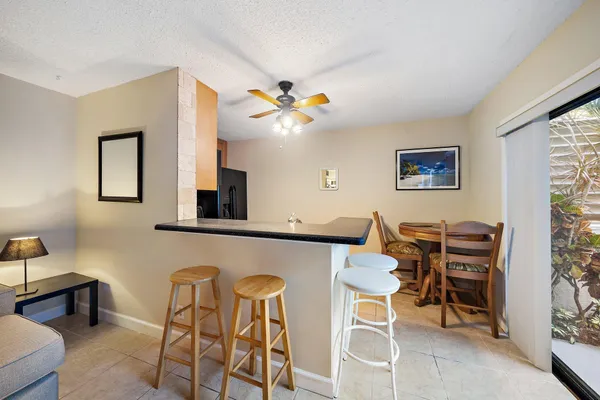 a kitchen with stainless steel appliances granite countertop a sink a stove and refrigerator